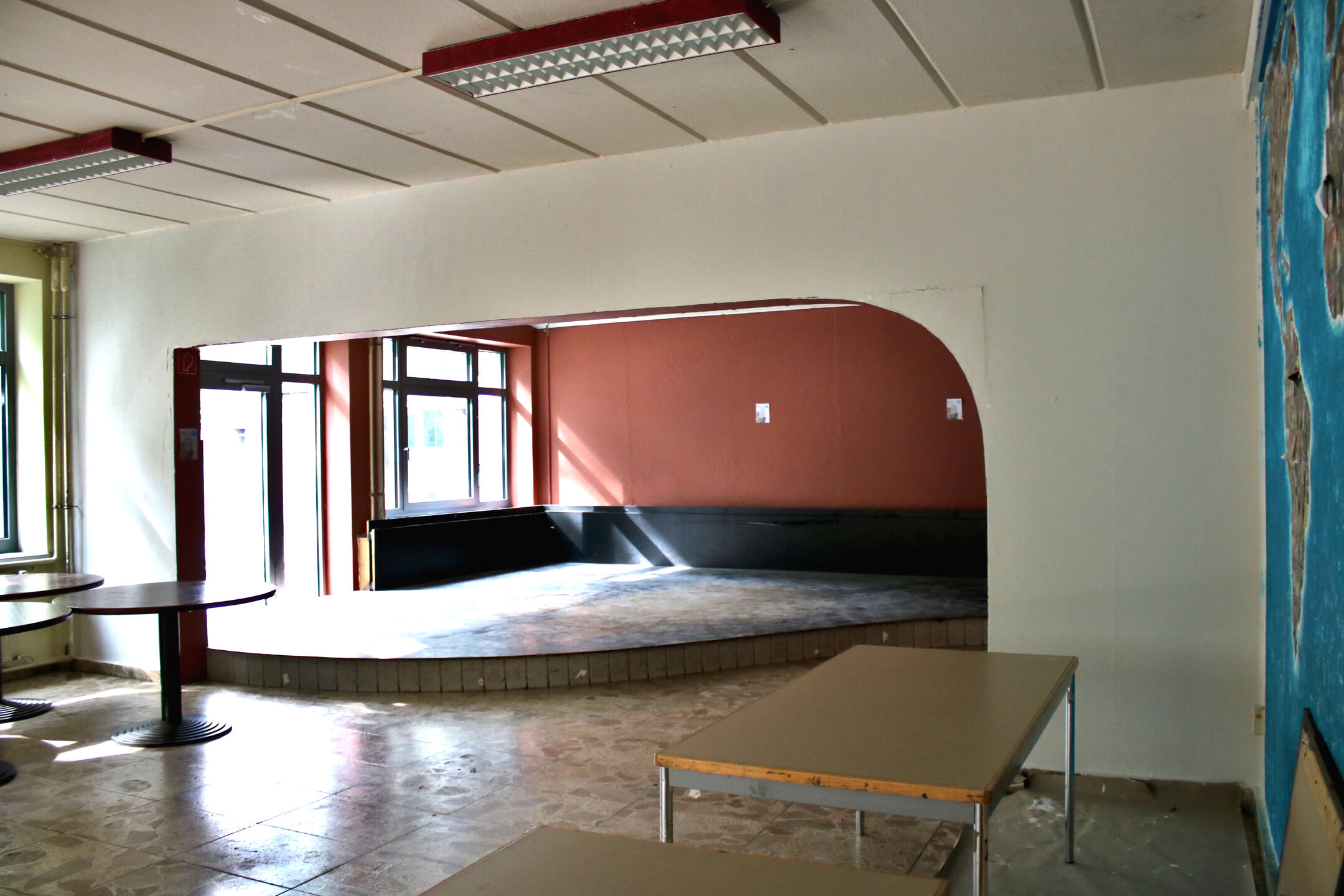 The Club of Cultures: a space with a large open area and a small raised platform (stage)